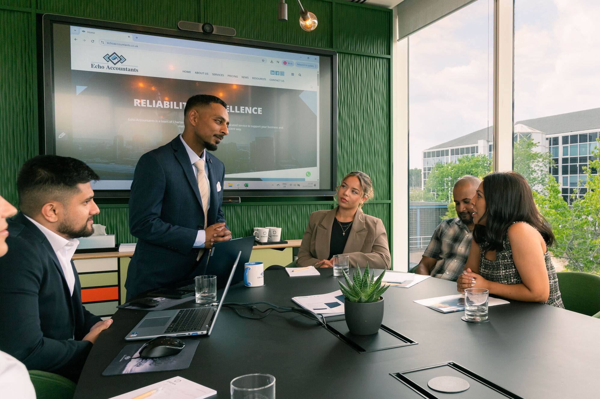 Joshua Dean taking clients through their numbers